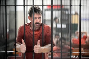 This file photo taken on March 6, 2009 shows Russian arms dealer Viktor Bout as he stands behind bars ahead of a court hearing at the Criminal Court in Bangkok. (Photo by CHRISTOPHE ARCHAMBAULT/AFP via Getty Images)