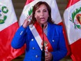 This handout picture released by the Peruvian Presidency shows Peru's President Dina Boluarte announcing on a televised message she will present a bill to parliament to advance the scheduled general elections from April 2026 to April 2024, at the Presidential Palace in Lima, on December 11, 2022.