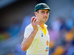 Australia's Pat Cummins gestures after a five wicket haul as he walks off at the conclusion of South Africa's innings during day two of the first cricket Test match between Australia and South Africa at the Gabba in Brisbane on December 18, 2022.