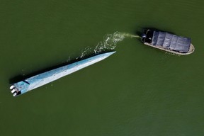 Aerial view of a seized narco-submarine towed by a Colombian Navy ship in Buenaventura, Valle del Cauca department, Colombia, on March 21, 2021. The submarine, which contained several packages of cocaine and was destined for the coasts of Mexico, belonged to a dissident armed group of the FARC guerrilla, according to authorities.