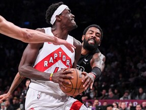 Brooklyn Nets guard Kyrie Irving attempts to steal the ball from Toronto Raptors forward Pascal Siakam during the second quarter at Barclays Center.