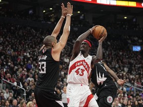Toronto Raptors forward Pascal Siakam tries to get a shot off against LA Clippers forward Nicolas Batum during the first half at Scotiabank Arena.