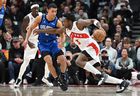 Raptors' OG Anunoby (right) dribbles the ball past Orlando Magic's Caleb Houstan during the first half at Scotiabank Arena on Saturday, Dec. 3, 2022. 