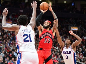 Toronto Raptors guard Gary Trent Jr.  shoots the ball over Philadelphia 76ers center Joel Embiid  and guard Tyrese Maxey in the second half at Scotiabank Arena.