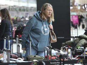 Shannon Koves searches in Pearson airport's Terminal 3 for her daughter's baggage that was destined for a ski trip to Kelowna for the holidays.