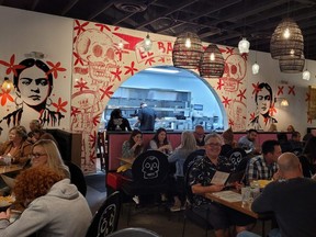 Diners enjoy the food and atmosphere at Barrio Queen, a restaurant at the Tempe Marketplace outdoor mall in Tempe, Ariz.