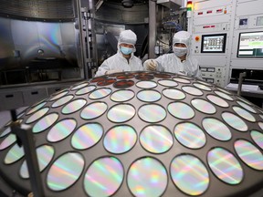 Employees work on the semiconductor chip production line of Jiangsu Azure Corp in Huaian, Jiangsu province, China, March 25, 2022.