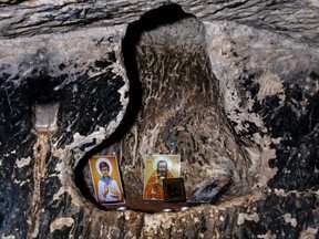 Religious imageries left by visitors are seen in an alcove in the wall of a cave that, according to the Israel Antiquities Authority, is the 2,000-year-old burial cave of Jesus' midwife, Salome, in the Lachish Forest in Israel, Dec. 20, 2022.
