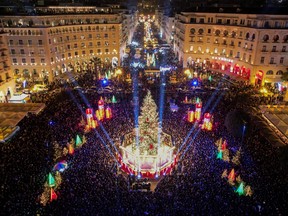 People attend a Christmas tree lighting ceremony on Aristotelous square in Thessaloniki, Greece, Dec. 7, 2022.