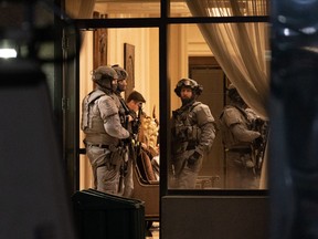 York Regional Police tactical officers are seen in the lobby of a condo building in Vaughan, Ont., Sunday, Dec. 18, 2022.