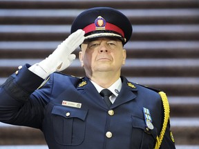 Incoming Toronto Police Chief Myron Demkiw salutes during the national anthem at a police change of command ceremony in Toronto, Monday, Dec.19, 2022.