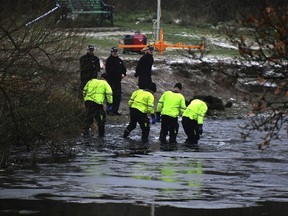 Police search teams at the scene after children fell through ice,in Babbs Mill Park in Kingshurst, Solihull, England, Monday, Dec. 12, 2022. Three young boys who fell through ice covering a lake in central England have died and a fourth remains hospitalized as weather forecasters issued severe weather warnings for large parts of the United Kingdom.