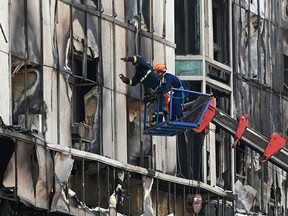 A rescue team searches for victims in a burned out part of the Grand Diamond City hotel-casino following a major fire at the complex in Poipet on December 30, 2022.