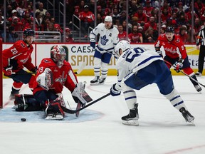 Washington Capitals goalie Charlie Lindgren makes a save on Michael Bunting of the Toronto Maple Leafs during the third period at Capital One Arena on Saturday, Dec. 17.