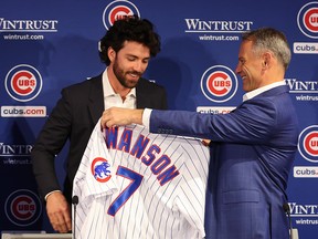 President Jed Hoyer of the Chicago Cubs presents a jersey to Dansby Swanson during his introductory press conference at Wrigley Field on December 21, 2022 in Chicago.