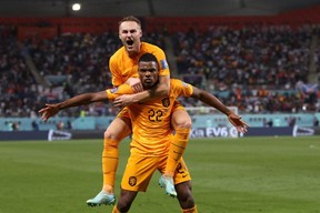 Netherlands’ Denzel Dumfries (22) celebrates with teammate Teun Koopmeiners after scoring his team’s third goal against the United States during the Qatar 2022 World Cup round of 16 match at Khalifa International Stadium in Doha, Saturday, Dec. 3, 2022.