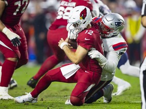 Arizona Cardinals quarterback Colt McCoy is sacked by New England Patriots defensive tackle Daniel Ekuale in the second half at State Farm Stadium.