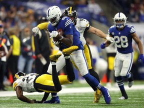 Pittsburgh Steelers outside linebacker T.J. Watt prepares to punch the ball after a catch by Indianapolis Colts tight end Jelani Woods during the second half at Lucas Oil Stadium.