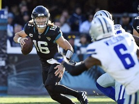 Jacksonville Jaguars quarterback Trevor Lawrence scrambles during the game against the Dallas Cowboys at TIAA Bank Field.