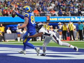 Los Angeles Rams tight end Tyler Higbee (89) scores on a 7-yard touchdown reception against Denver Broncos cornerback Damarri Mathis (27) in the first half at SoFi Stadium Dec 25, 2022.
