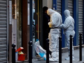 French scientific police work on Rue d'Enghien after gunshots were fired, killing and injuring several people, in a central district of Paris, France, December 23, 2022.