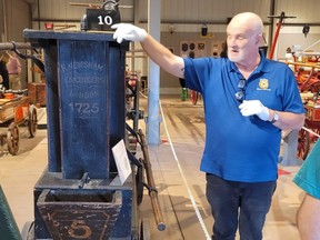 A 1725 Newsham (a manual pumper) is displayed by Mark Moorhead, the curator of education of the Hall of Flame Museum of Firefighting in Tempe, Ariz.