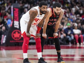 Nets’ Kyrie Irving stands with Raptors’ Fred VanVleet at the Scotiabank Arena on Friday. Irving hit a game-winning three-point shot at the buzzer to sink the Raptors.