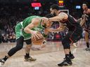 Boston Celtics forward Jayson Tatum (0) tries get around Toronto Raptors guard Fred VanVleet on Monday night. 