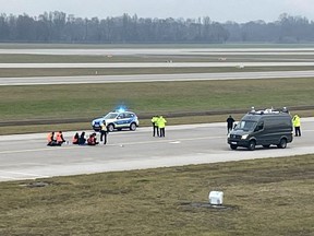 Activists of "Letzte Generation" (Last Generation) glued themselves to the tarmac of the airport to protest for a speed limit on highways as well as for affordable public transport, in Munich, Germany, December 8, 2022.