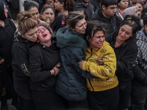 Relatives and friends mourn during the funeral procession of Costas Fragoulis, a 16-year old Roma who was fatally shot by police, in Thessaloniki, Greece, December 15, 2022.