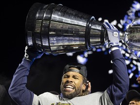 Argonauts defensive back Shaquille Richardson hoists up the Grey Cup after defeating the Winnipeg Blue Bombers for the 109th Grey Cup at Mosaic Stadium on Sunday, November 20, 2022 in Regina.