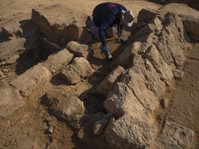 A member of a Palestinian excavation team works in a newly discovered Roman era cemetery in the Gaza Strip, Sunday, Dec. 11, 2022.