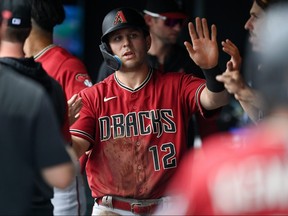 Daulton Varsho of the Arizona Diamondbacks celebrates in the dugout after a second inning run scored against the Colorado Rockies at Coors Field on July 3, 2022 in Denver, Colorado.