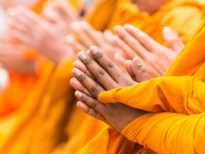 Hands of monks in prayer.