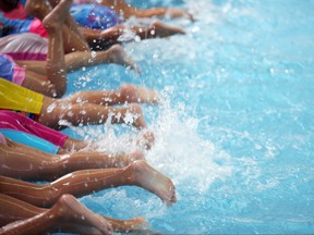 Group of children at swimming pool learning to swim