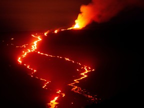 The Mauna Loa volcano erupts, as seen from Mauna Kea near Hilo, Hawaii, Dec. 6, 2022.