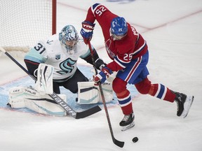 Montreal Canadiensâ€™ Ryan Poehling moves in on Seattle Kraken goaltender Philipp Grubauer during first period NHL hockey action in Montreal, Saturday, March 12, 2022.