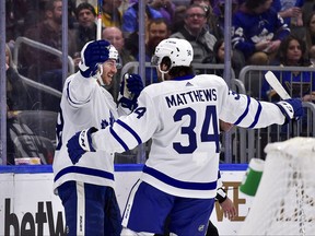 Toronto Maple Leafs left wing Michael Bunting celebrates with center Auston Matthews after scoring a goal against the St. Louis Blues during the first period at Enterprise Center.