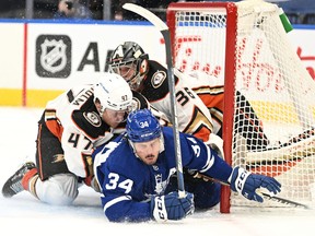 Toronto Maple Leafs forward Auston Matthews crashes into Anaheim Ducks goalie John Gibson after being hooked to the ice by Ducks defenseman Hampus Lindholm in the second period at Scotiabank Arena.