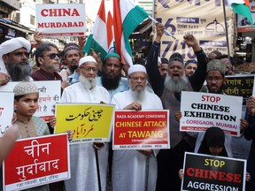 Demonstrators hold signs during a protest against China, following a border scuffle at the Tawang sector of India's northeastern Himalayan state of Arunachal Pradesh that led to injuries to soldiers on both sides, in Mumbai, India, December 13, 2022.