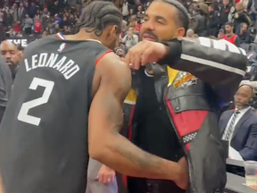 Former Raptor Kawhi Leonard (left) and Drake say hello following a Los Angeles Clippers game against the Toronto Raptors.