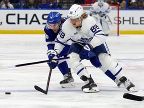 Leafs’ William Nylander fights off Tampa Bay’s Brandon Hagel at Amalie Arena in Tampa last night.  Getty Images