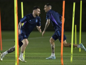 Argentina's forward #10 Lionel Messi (L) and midfielder #11 Angel Di Maria take part in a training session at Qatar University in Doha on Thursday.