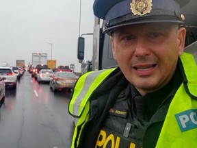 OPP Sgt. Kerry Schmidt, with the Highway Safety Division is stuck - along with a salting truck - on the Garden City Skyway in St. Catharines. OPP Highway Safety Division