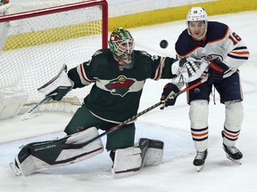 Minnesota Wild goalie Cam Talbot, left, deflects a shot next to Edmonton Oilers' Zach Hyman during the second period of an NHL hockey game Tuesday, April 12, 2022, in St. Paul, Minn.