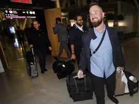 Pivot  Airlines employee Alexander Rozov and fellow flight members at Toronto Pearson International  Airport, Thursday December 1, 2022, after returning to Canada from the Dominican Republic where they had been detained while reporting a bag of cocaine onboard their plane in April of this year.