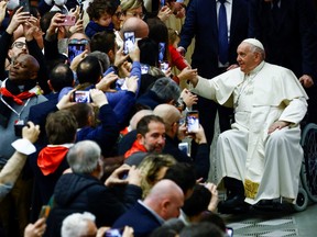 Pope Francis greets people during a meeting with CGIL executives and delegates at the Vatican, Dec. 19, 2022.