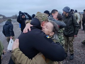 A woman embraces a Ukrainian prisoner of war after a swap, amid Russia's attack on Ukraine, in an unknown location, Ukraine December 31, 2022.