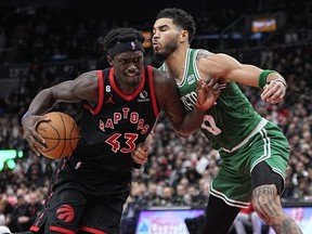 Raptors forward Pascal Siakam (left) drives to the net against Celtics forward Jayson Tatum (right) during second half NBA action at Scotiabank Arena in Toronto, Monday, Dec. 5, 2022.