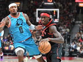 Raptors forward Pascal Siakam (right) dribbles past Phoenix Suns forward Torrey Craig in the first half at Scotiabank Arena on Friday night.